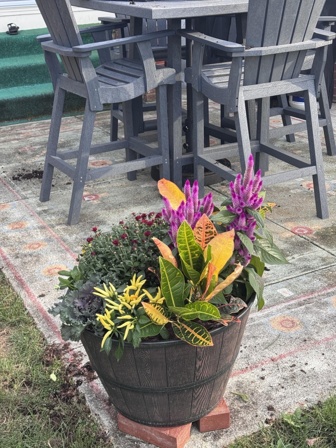 Fall planter beside an outdoor dining area