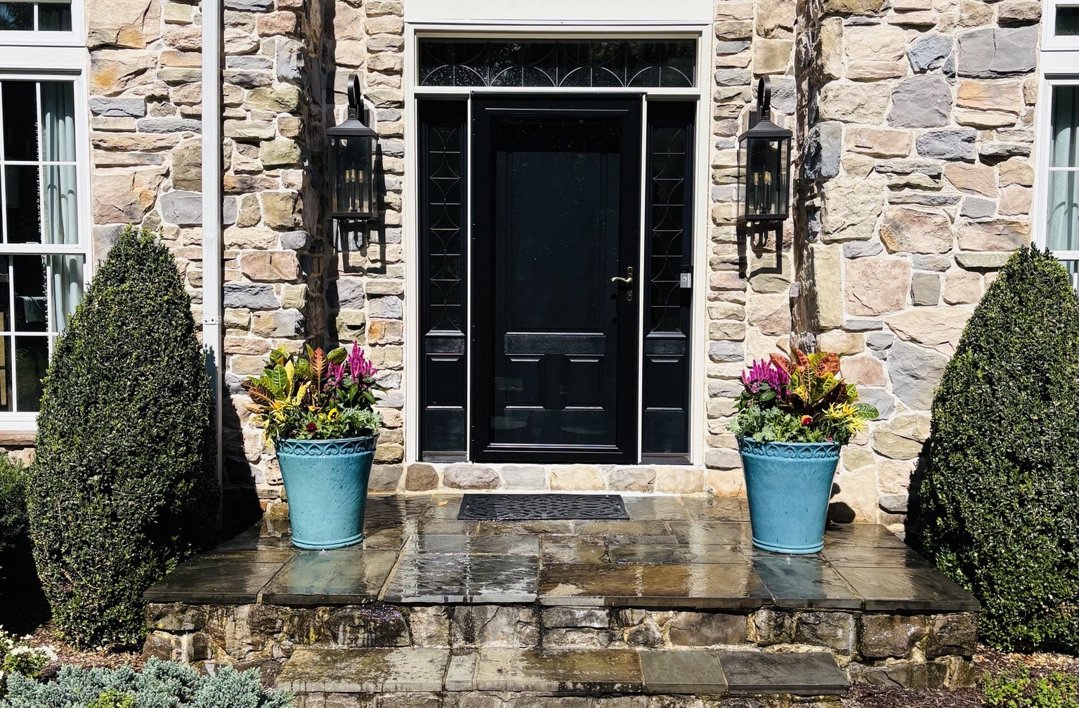 Matching planters flanking a stone front door