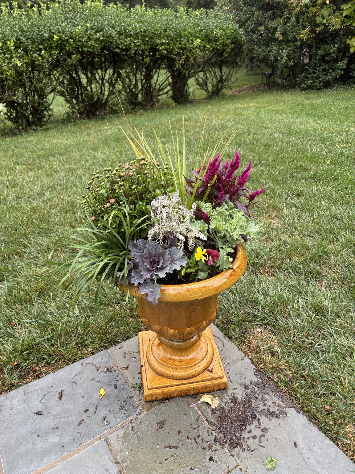 Colorful fall urn on a garden path