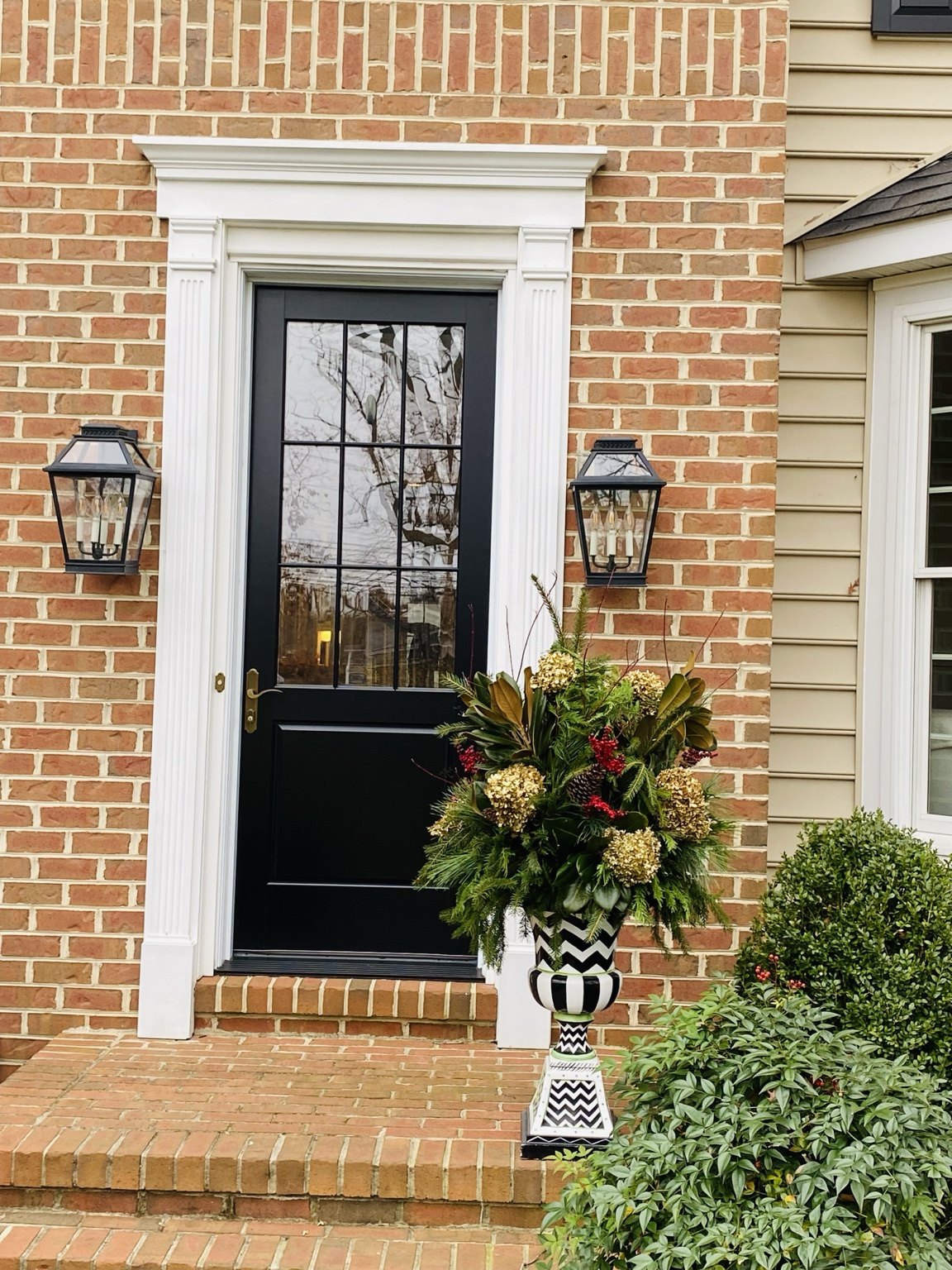 Holiday planter complementing a brick front entrance
