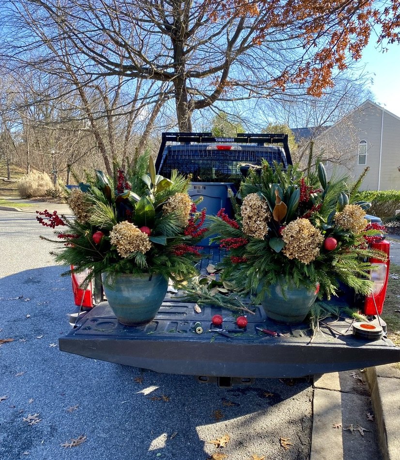 Holiday planters arranged in a pickup bed, ready for delivery