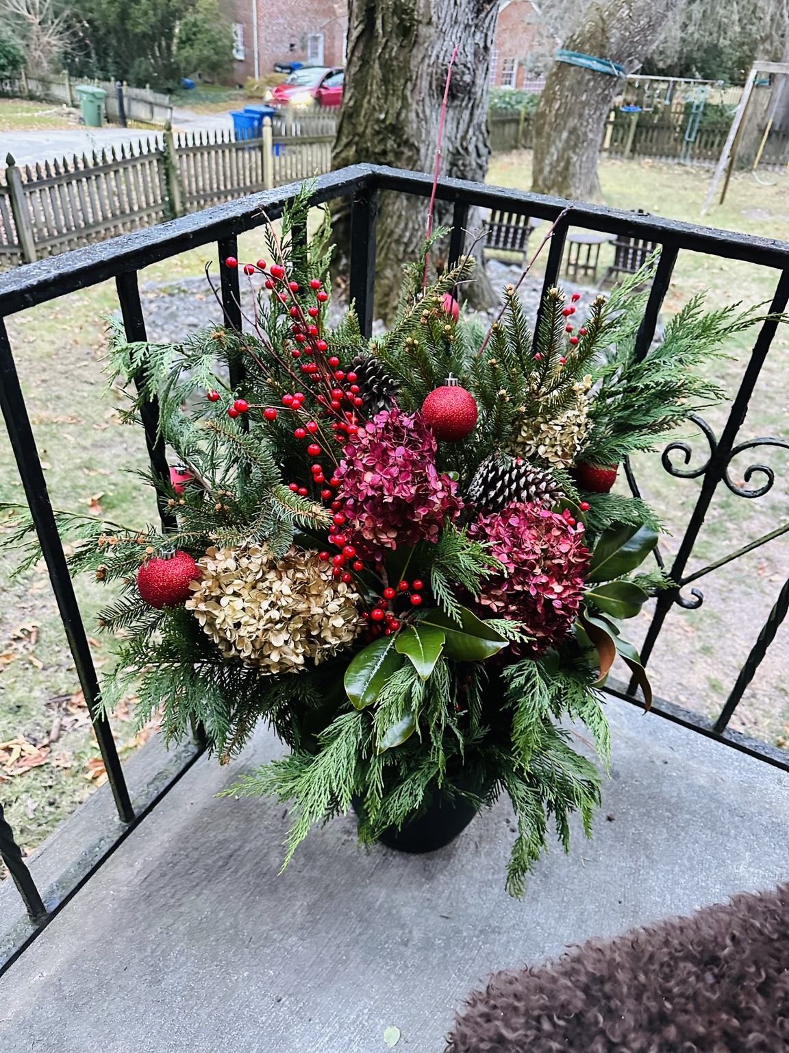 Mixed evergreen holiday planter on a balcony overlooking the water