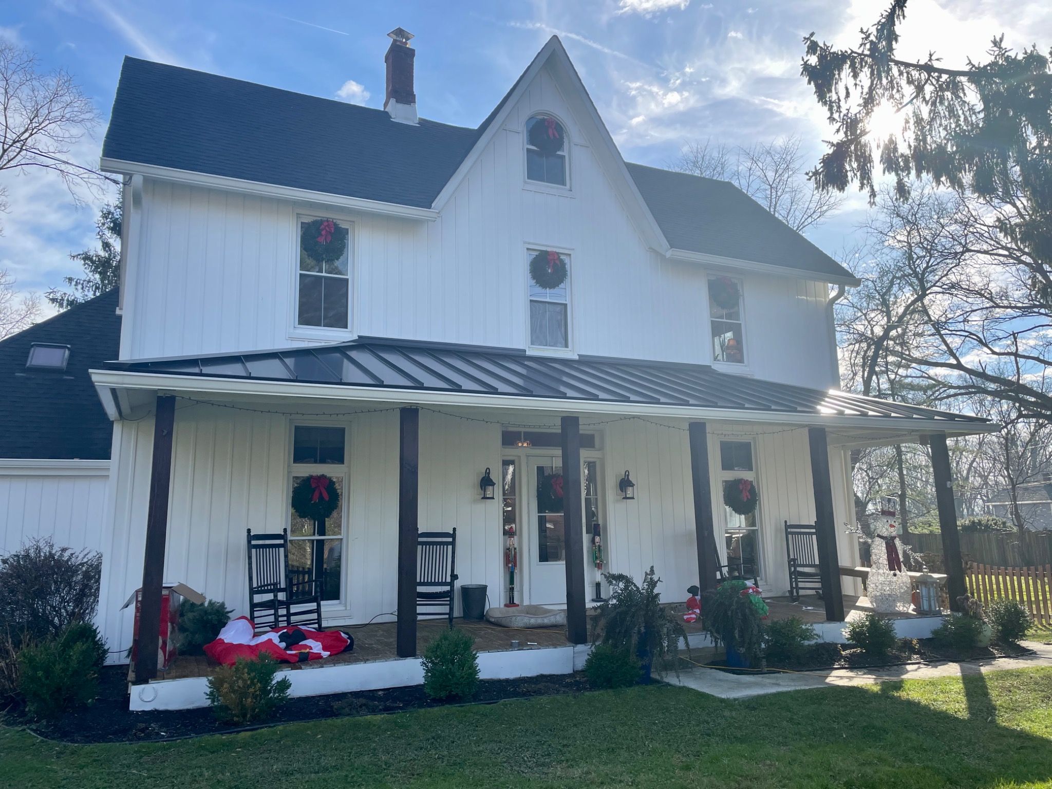 White home dressed with matching holiday planters and window boxes