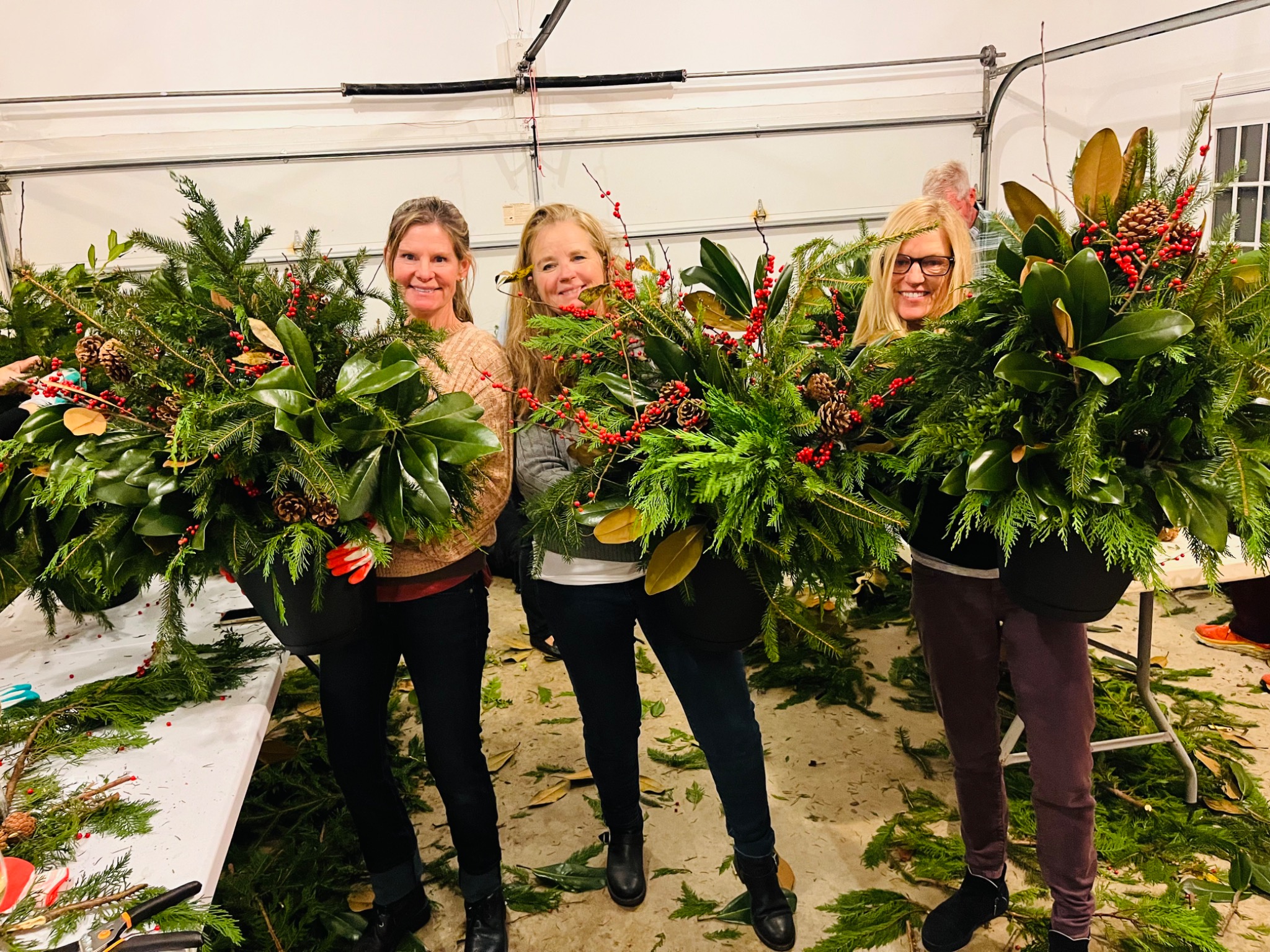 Guests showing their finished evergreen planters