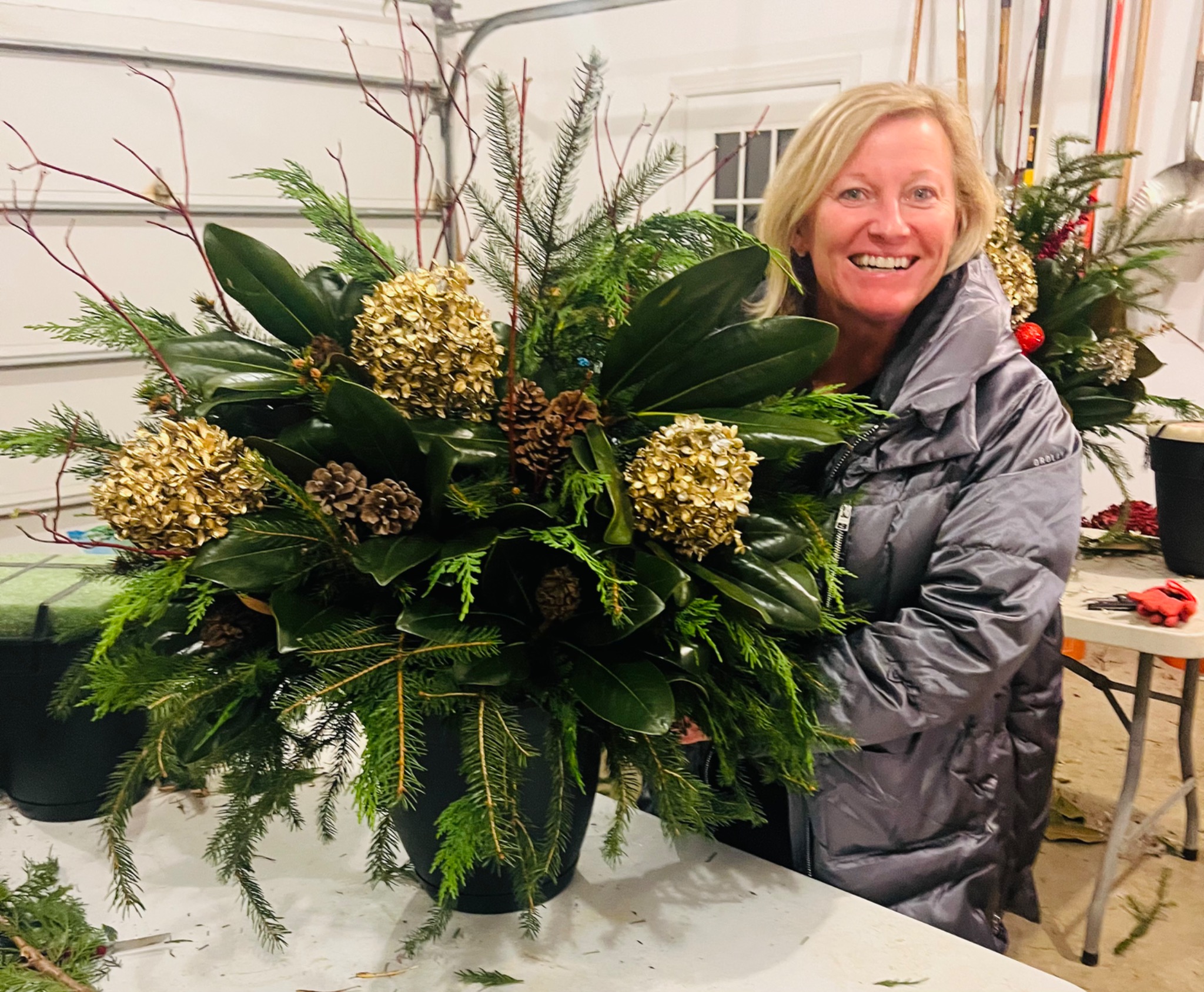 Guest beside a holiday planter with hydrangeas and magnolia