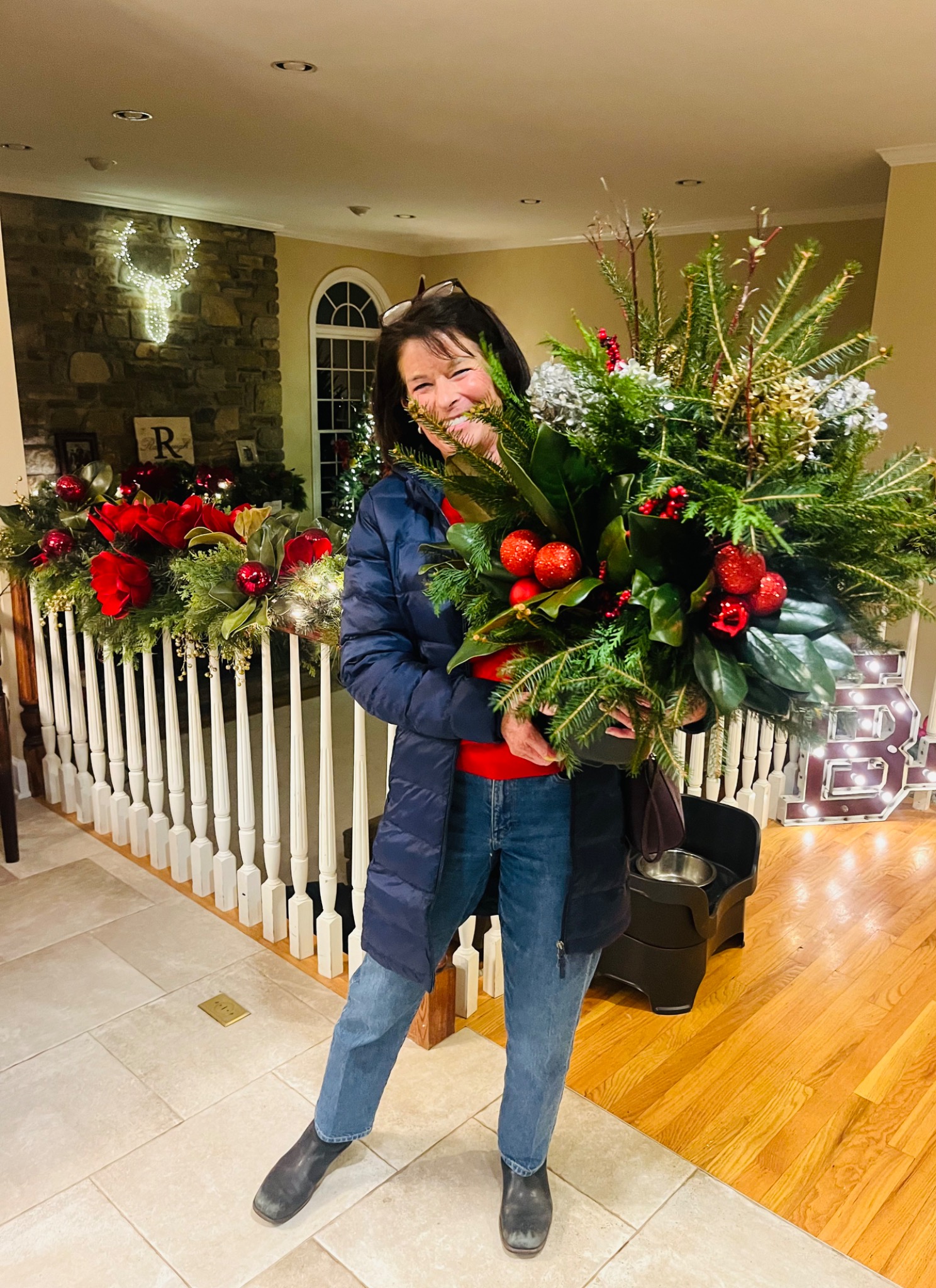 Guest holding a red and white holiday arrangement