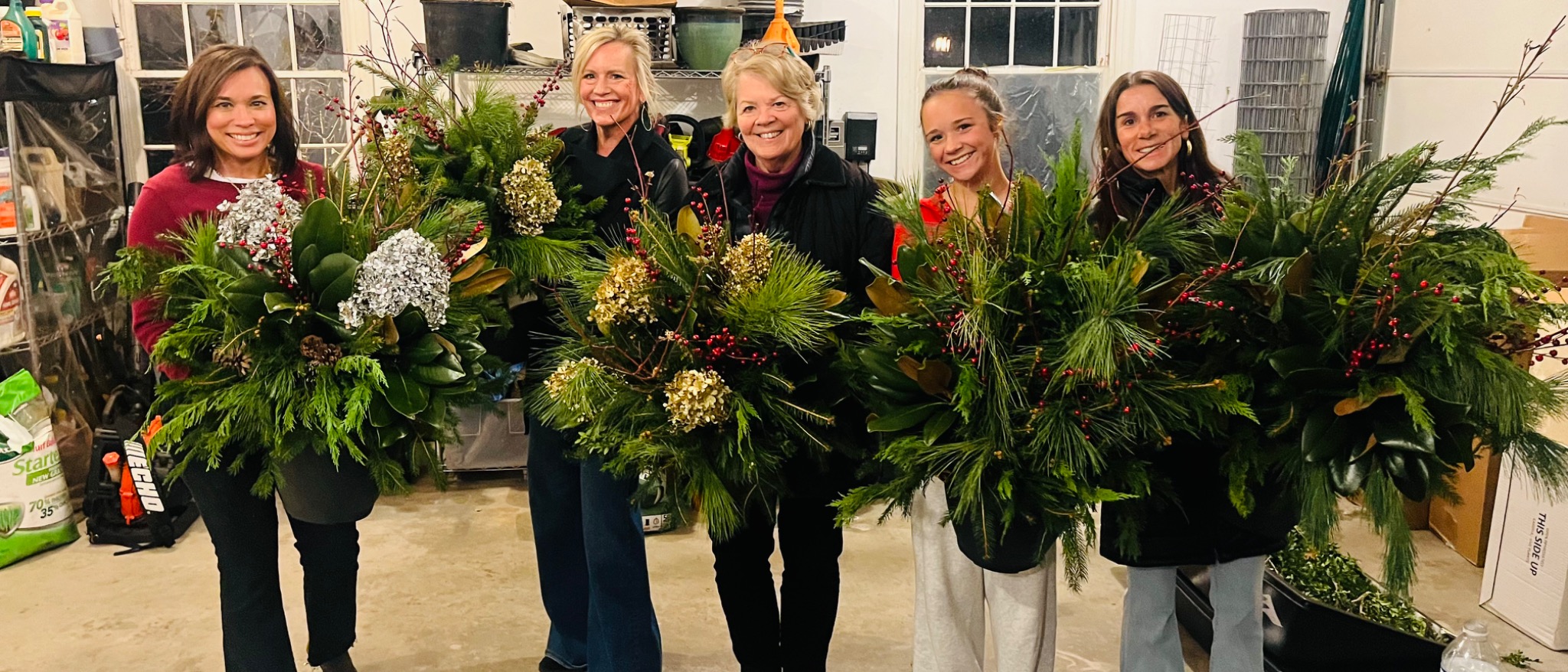 Workshop guests standing with their finished planters
