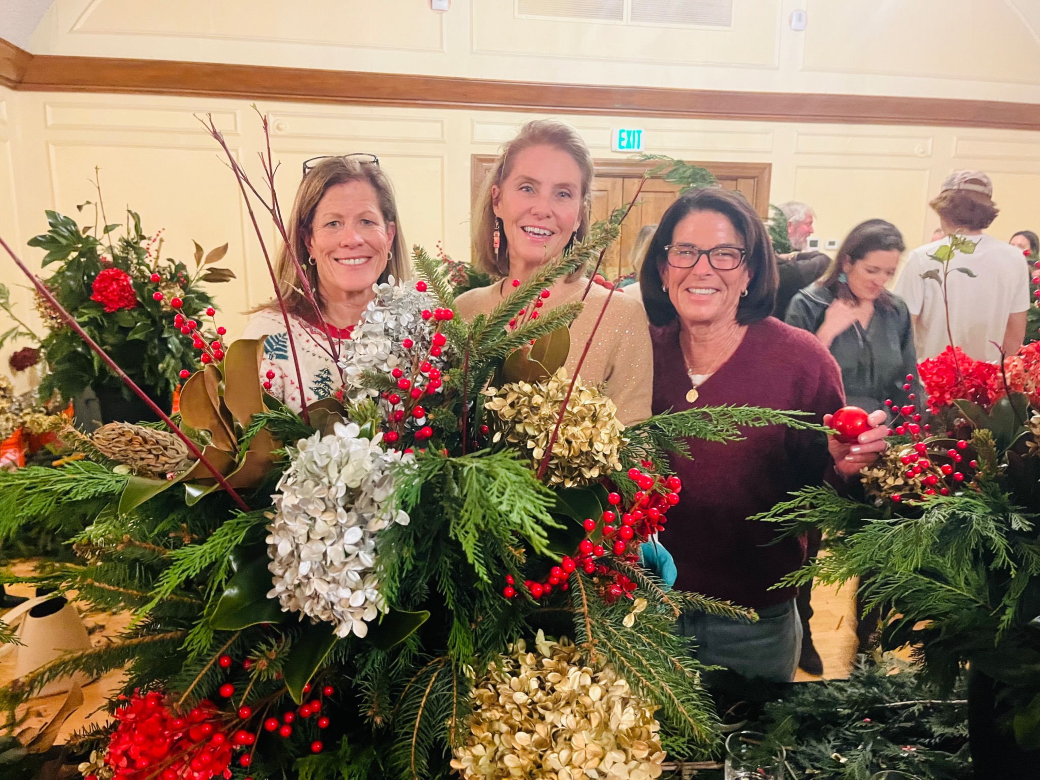 Friends showing their finished holiday planters