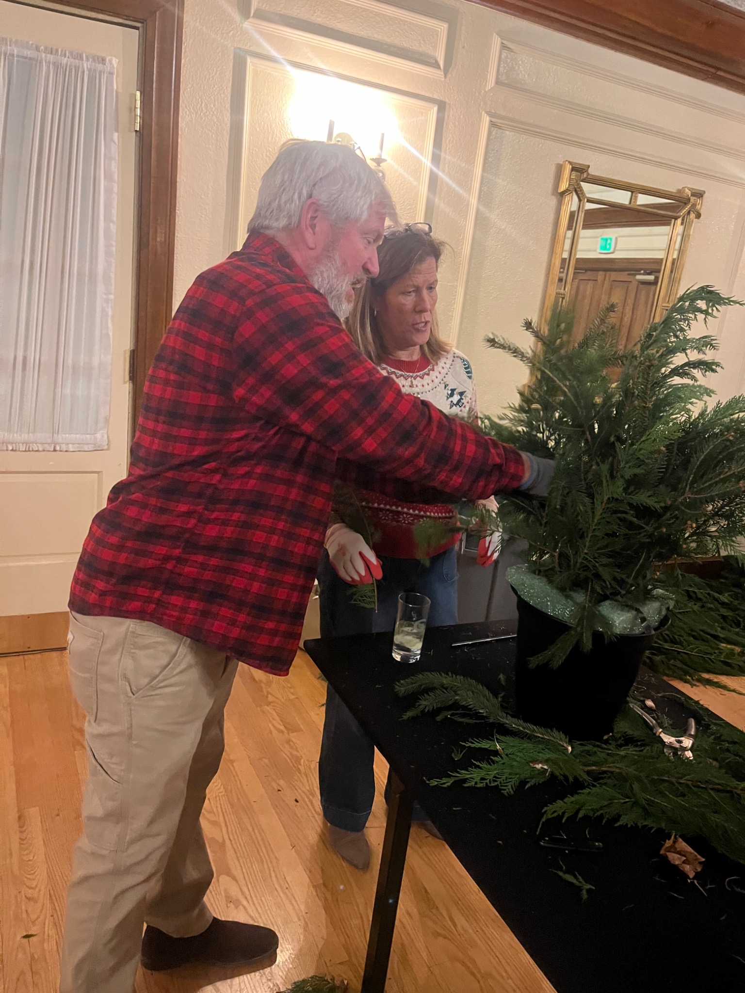 Derek helping a guest build her evergreen planter