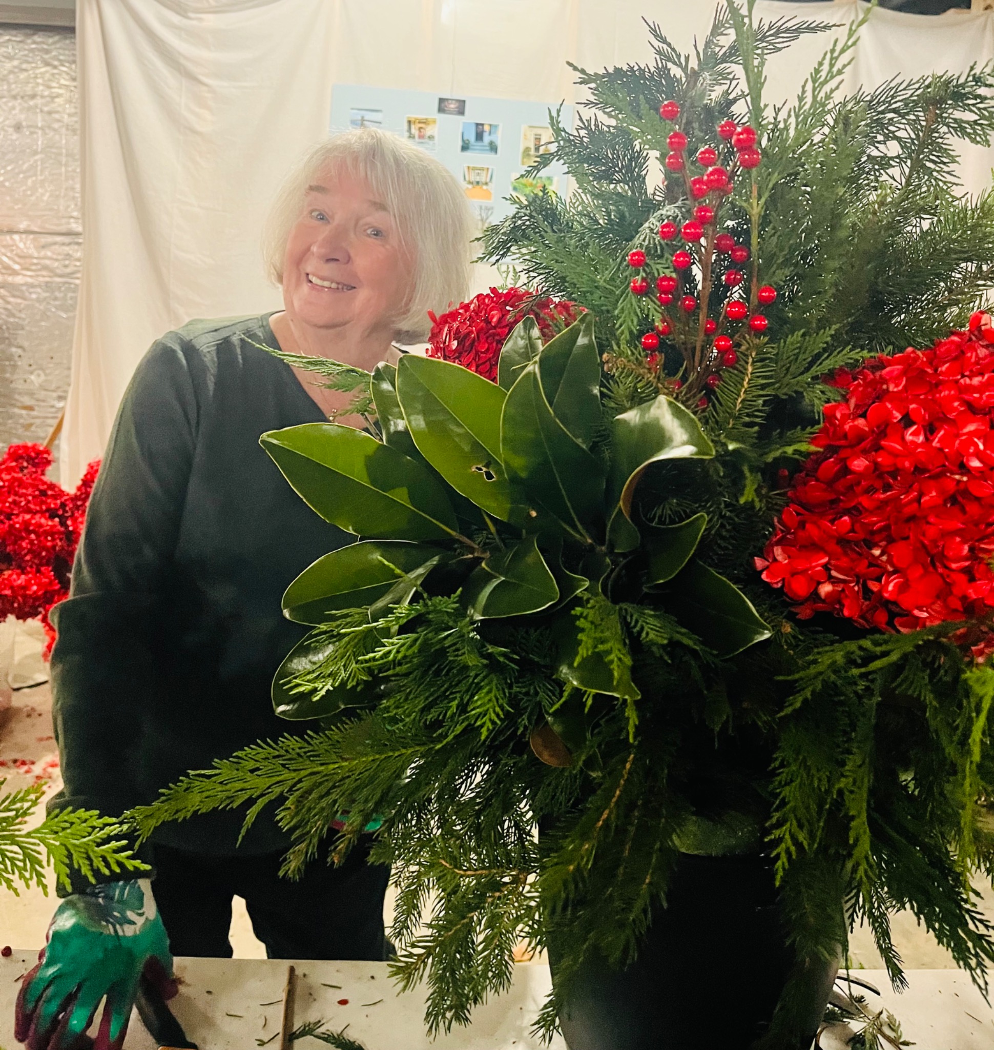 A guest with a festive red berry and evergreen arrangement