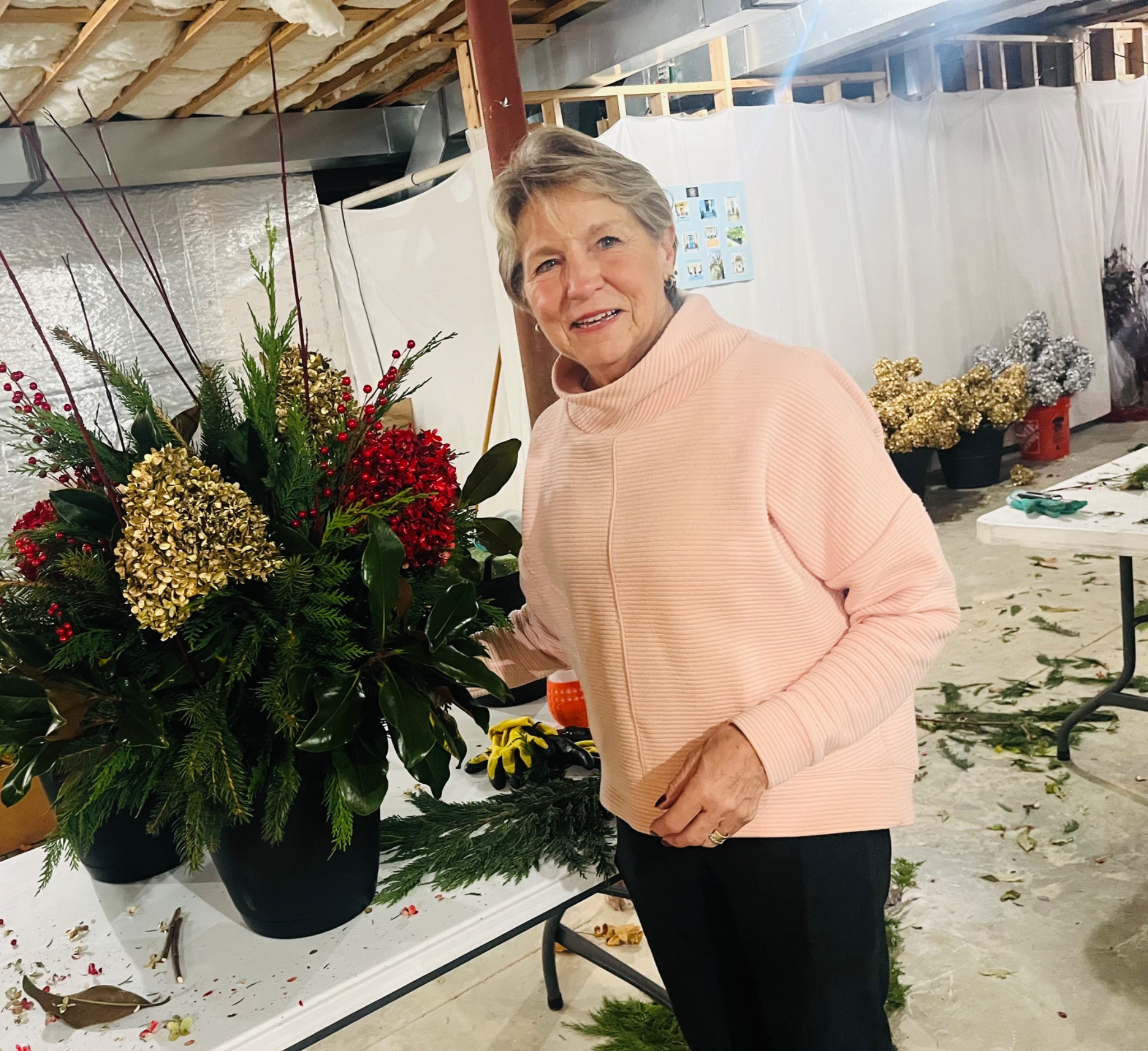 A guest beside a freshly made evergreen holiday planter