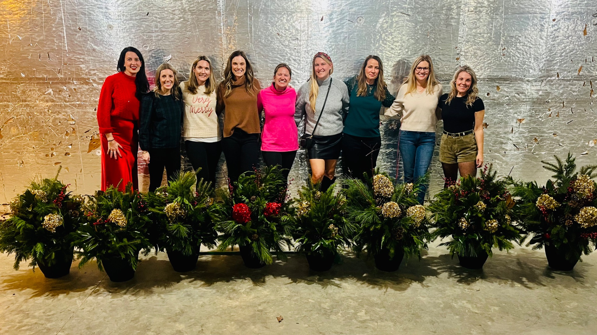 Workshop guests gathered behind their finished holiday planters