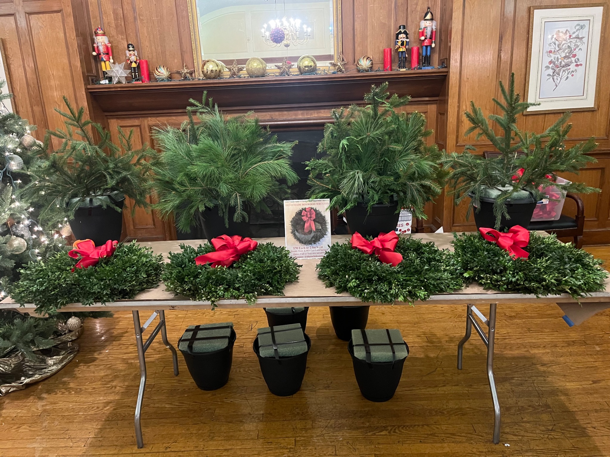 Holiday greenery and planters set out for a seasonal workshop