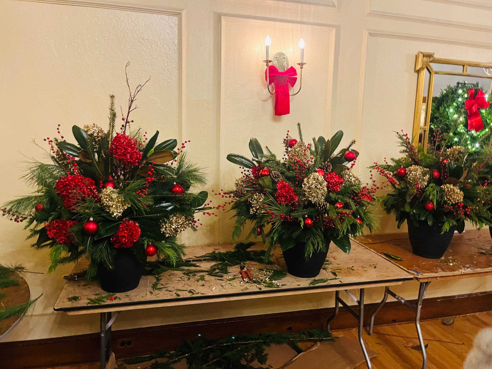 A display of finished holiday arrangements at a workshop