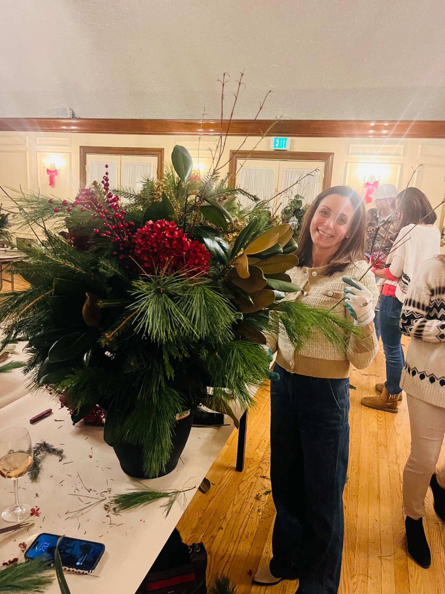 A guest adding the finishing touches to her holiday planter