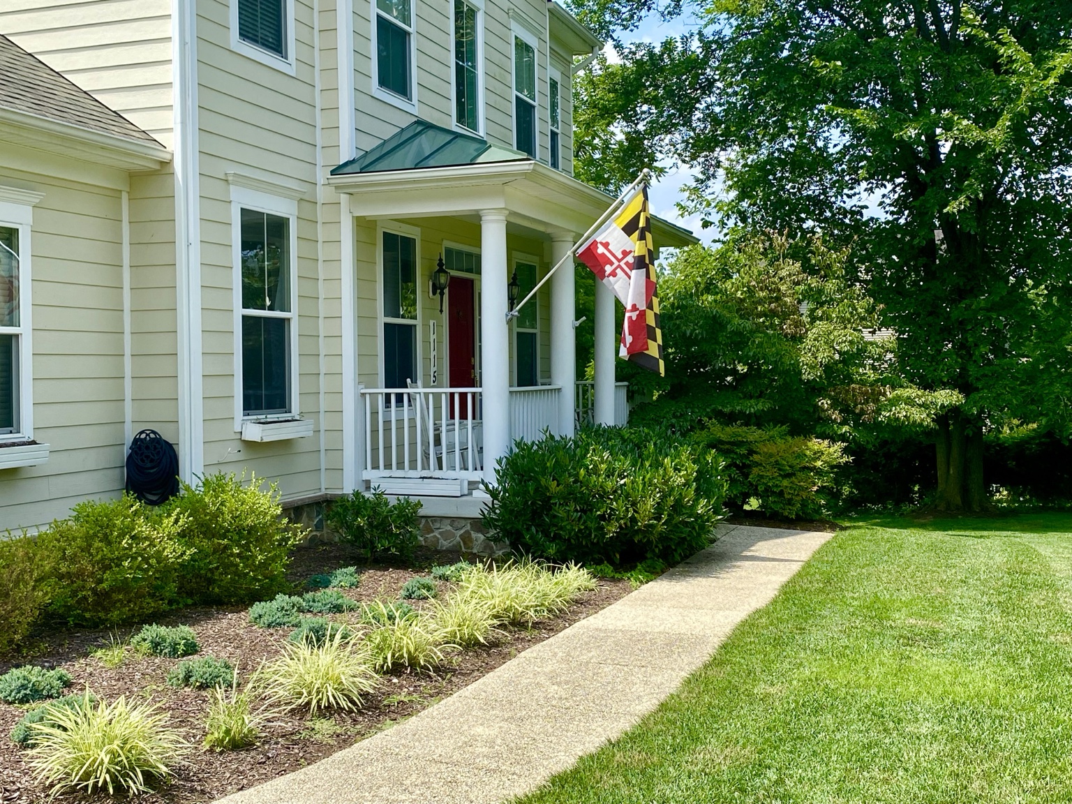 Front entry garden with low shrubs and a curved walkway