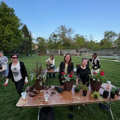 Guests planting seasonal containers together outdoors