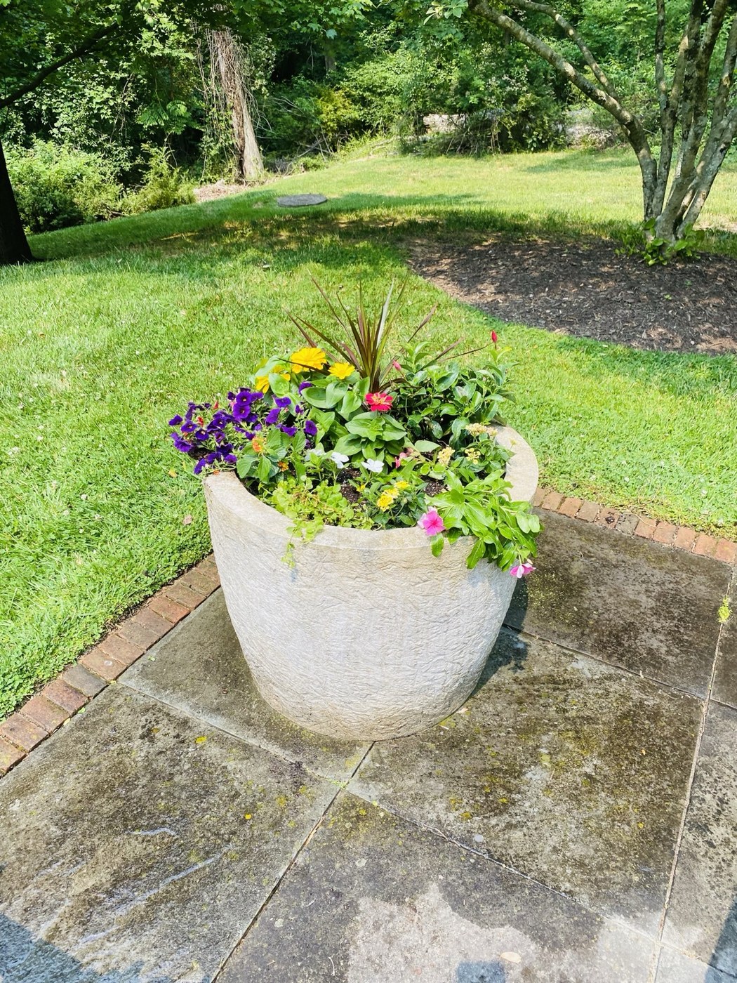 A white urn filled with soft summer color